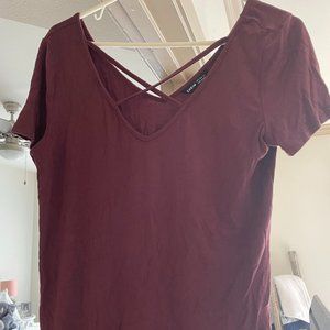 maroon t-shirt with criss cross in front